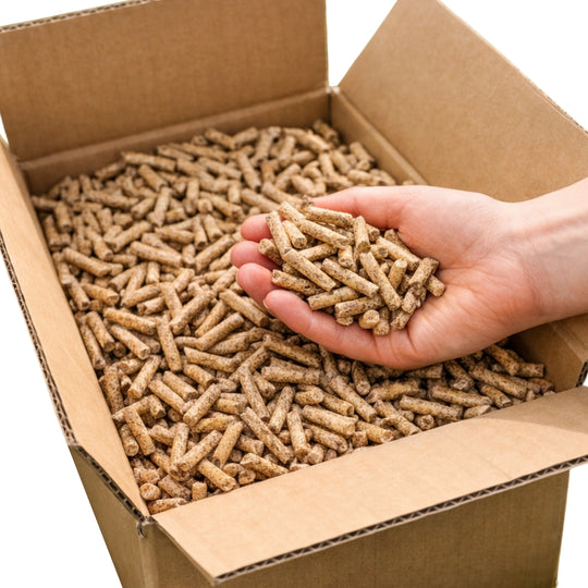 Hand holding Gardenflare Premium wood pellets above an open cardboard box containing 3.5 kg of wood pellets against a white background.